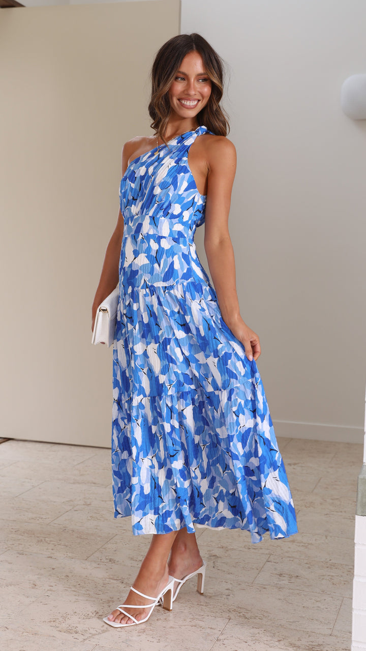 Women blue floral print midi dress, side profile, showing flow of tiered skirt