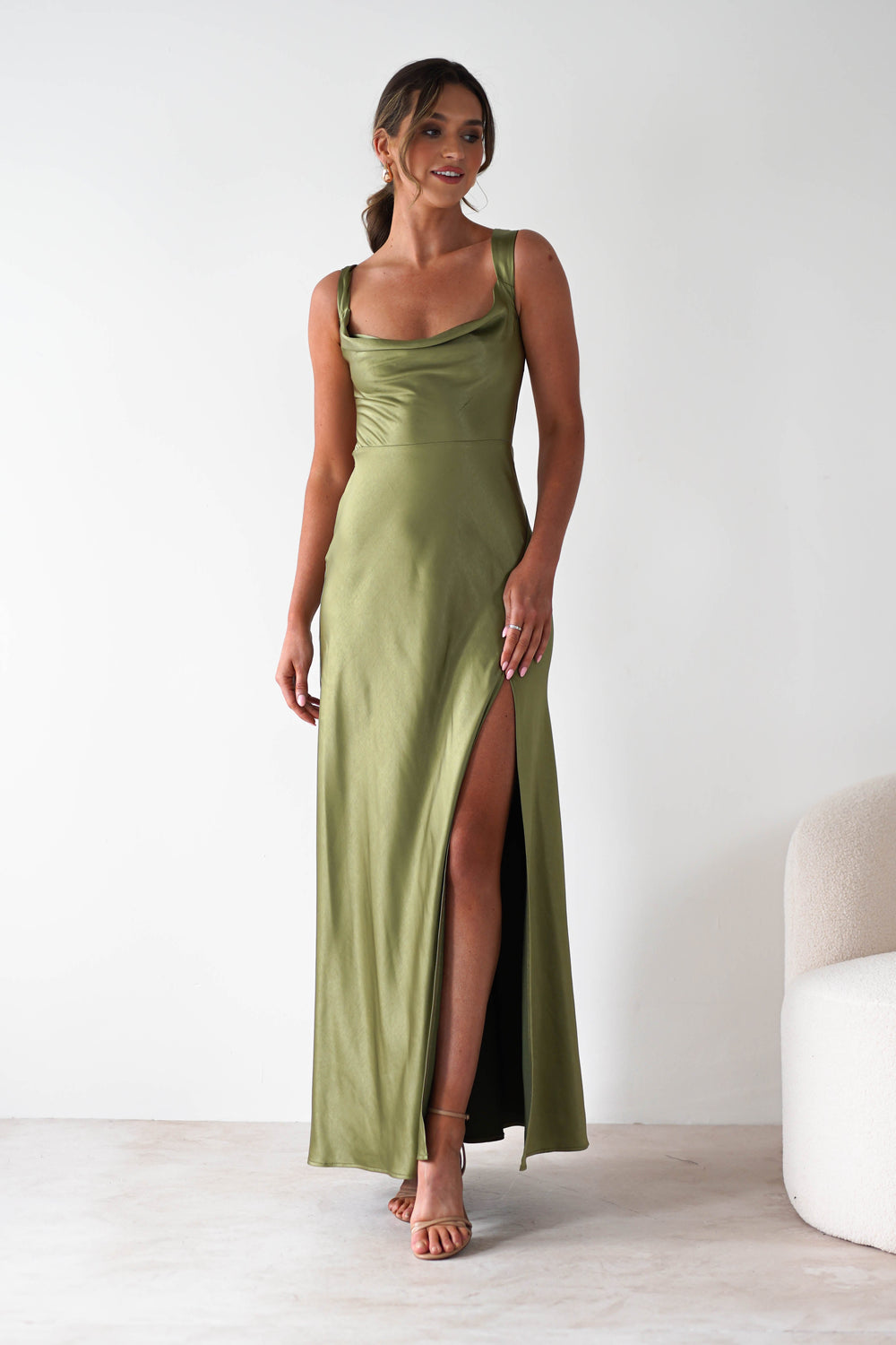 Women olive green satin cowl neck maxi dress with a thigh-high side slit, standing pose.