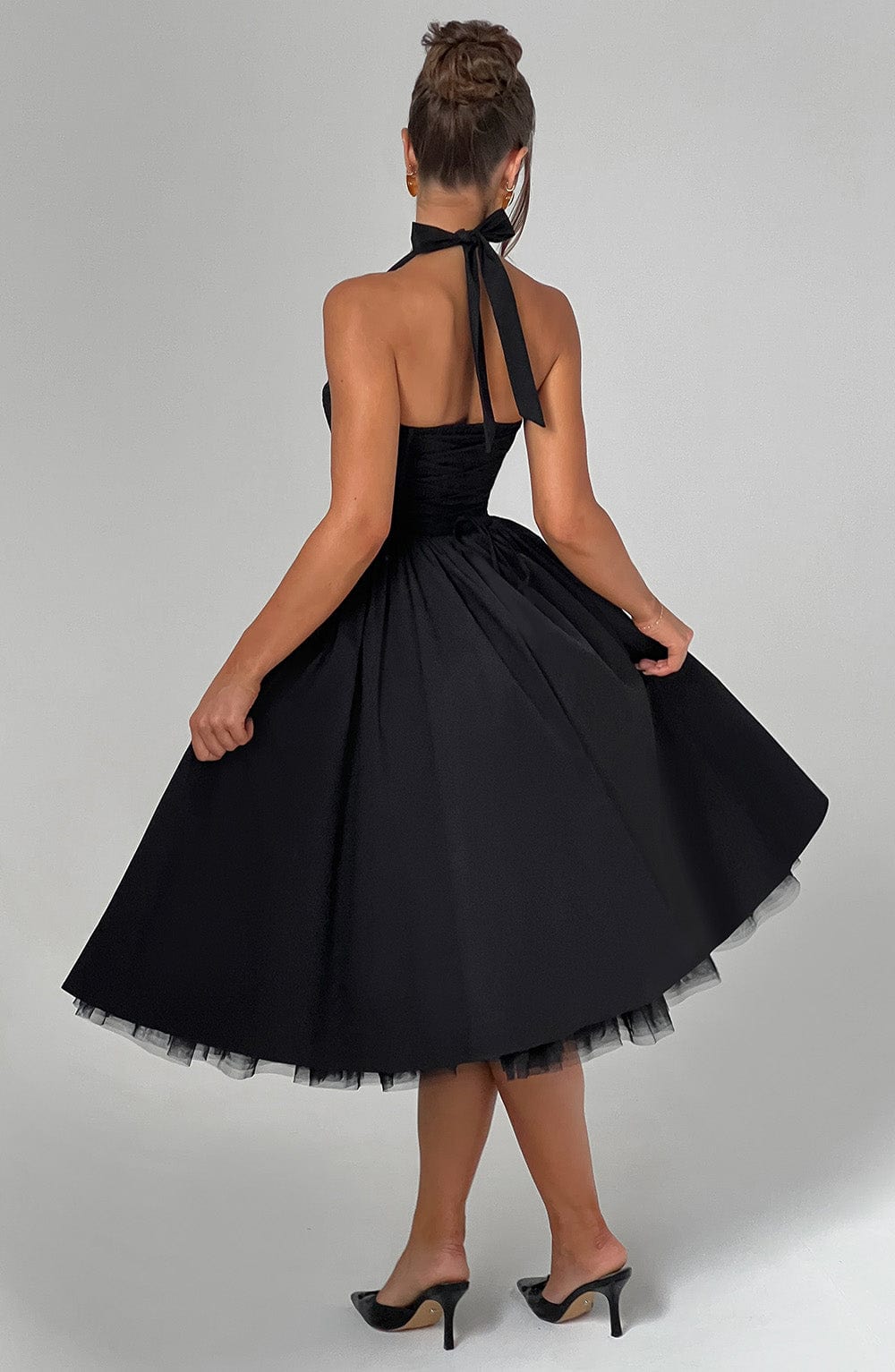 Women black halter neck midi dress with tie neck and full skirt, back view