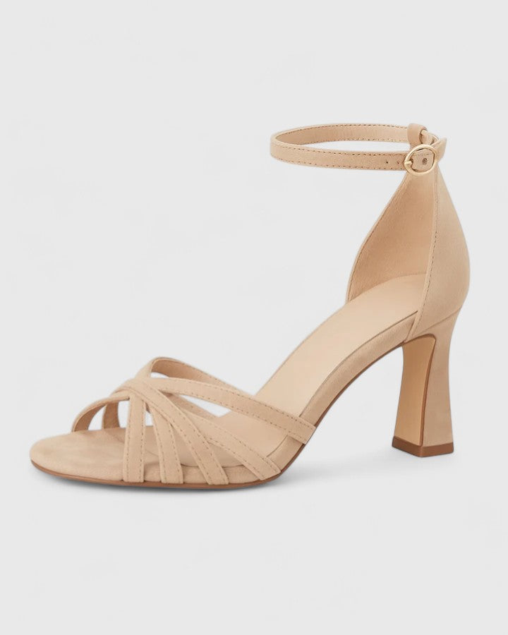 Women's nude ankle strap block heels with flared block heel and buckle detail.