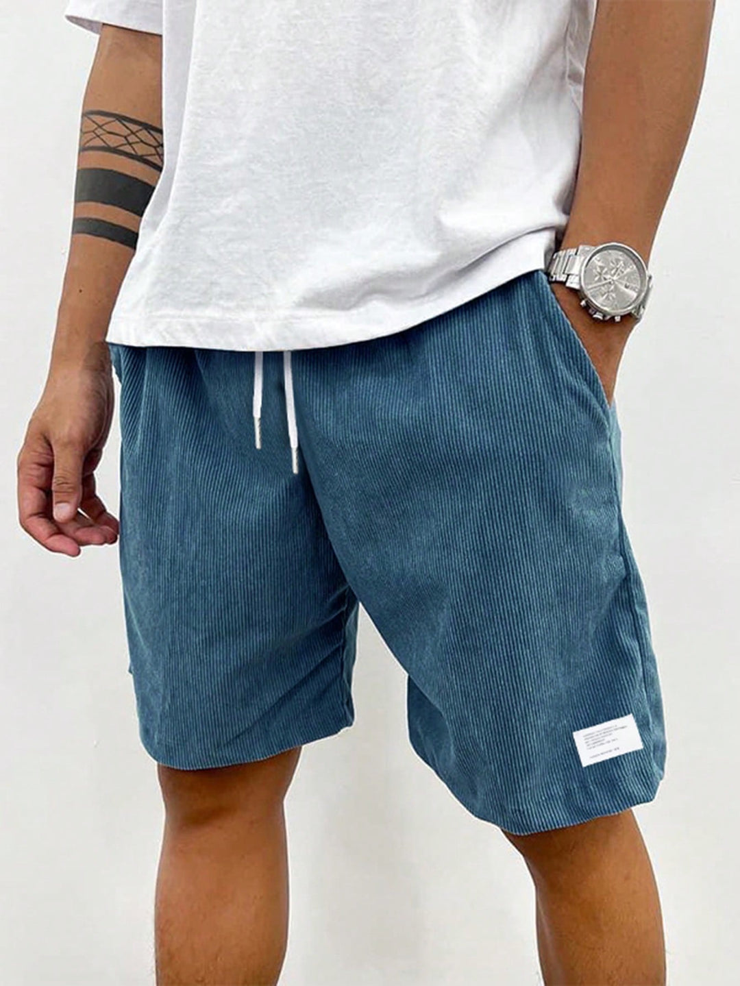 Men teal corduroy drawstring shorts with side pocket detail on model