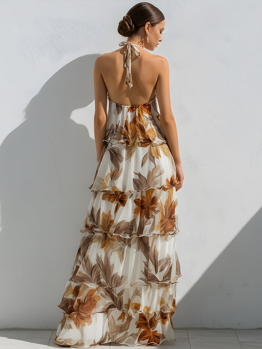 Women white floral halter neck tiered ruffle maxi dress shown from the back, highlighting the open back design.