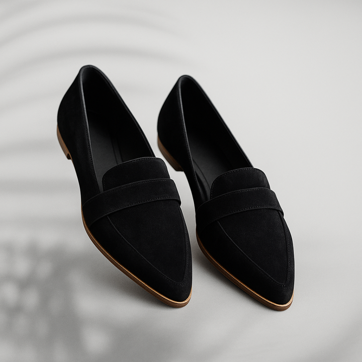 Women black pointed toe slip on loafers pair, side angle view, with a decorative vamp strap