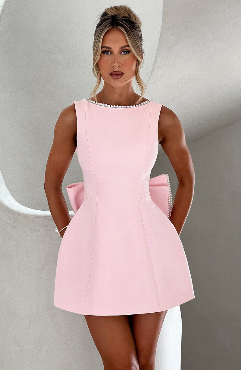 Women light pink mini dress with pearl boat neckline and large back bow