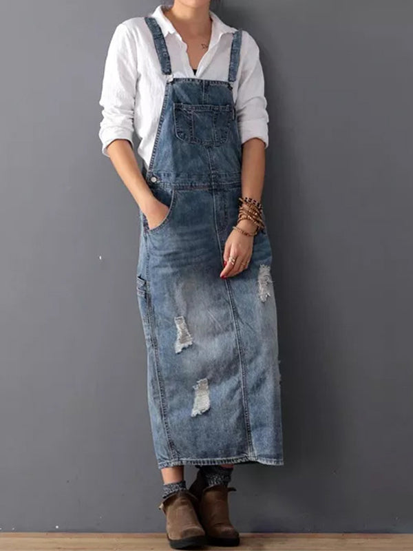 Women blue distressed denim pinafore midi dress, full length view with hands in pockets