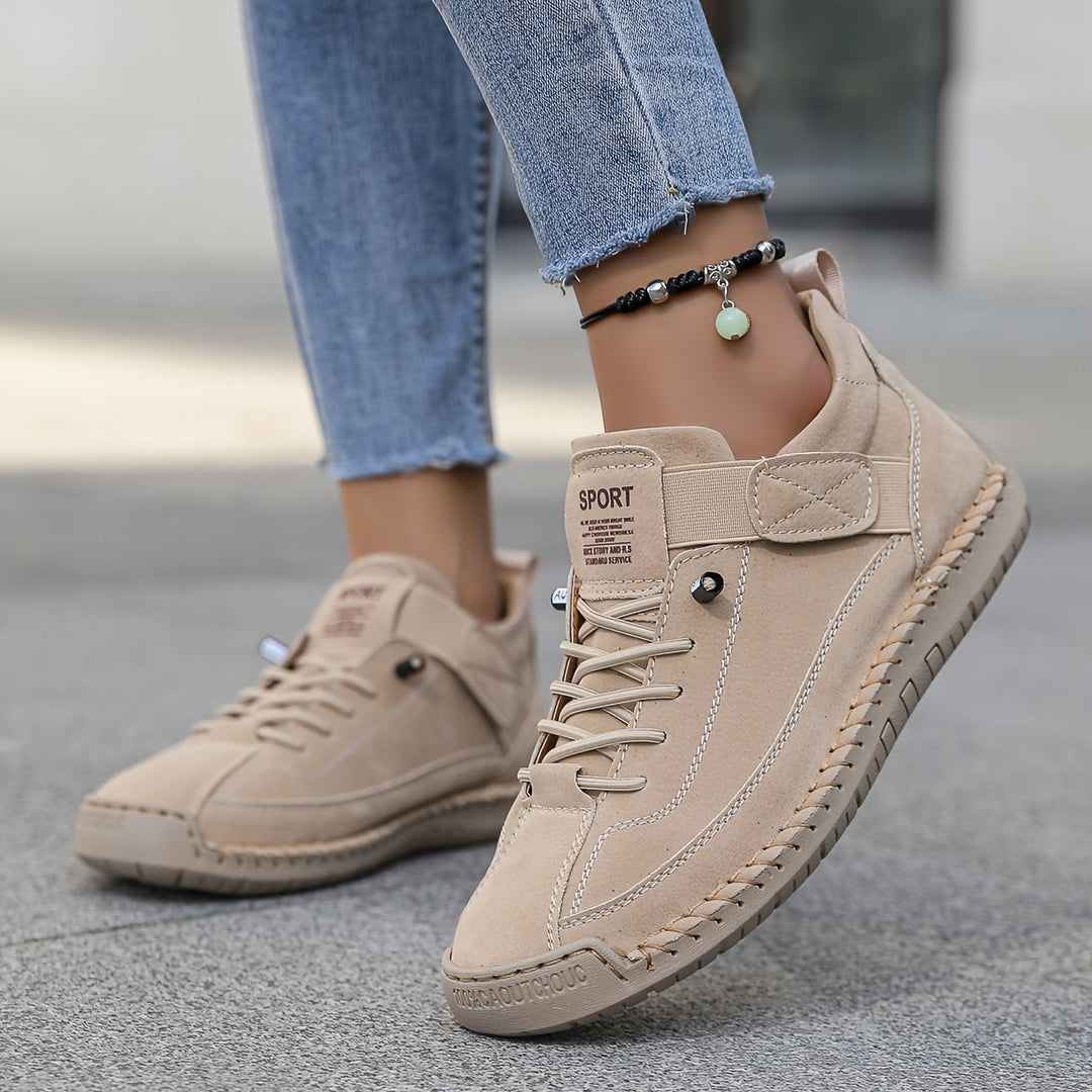 Women's beige casual lace-up platform sneakers with visible stitched sole detailing and hook and loop strap