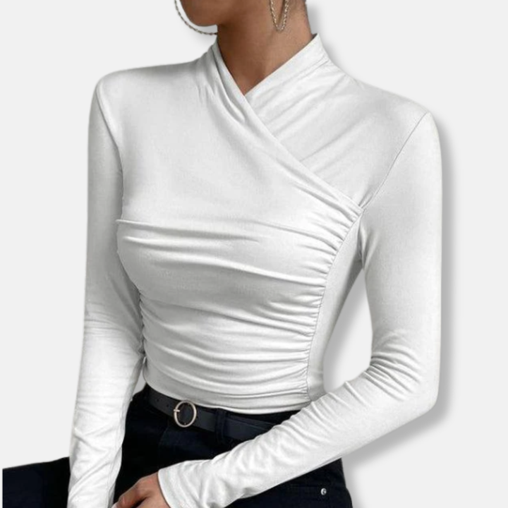 Women white long sleeve cross neck top with ruched side detail worn with black pants showing full torso