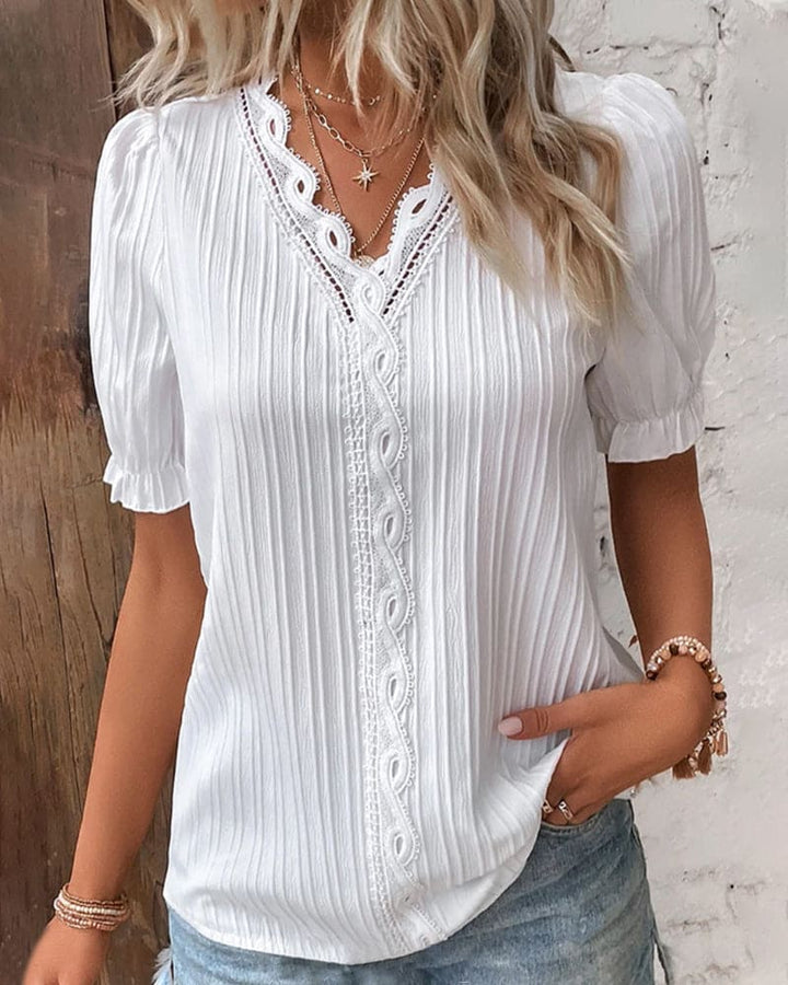 Women white lace V neck short puff sleeve blouse with textured fabric, front view.