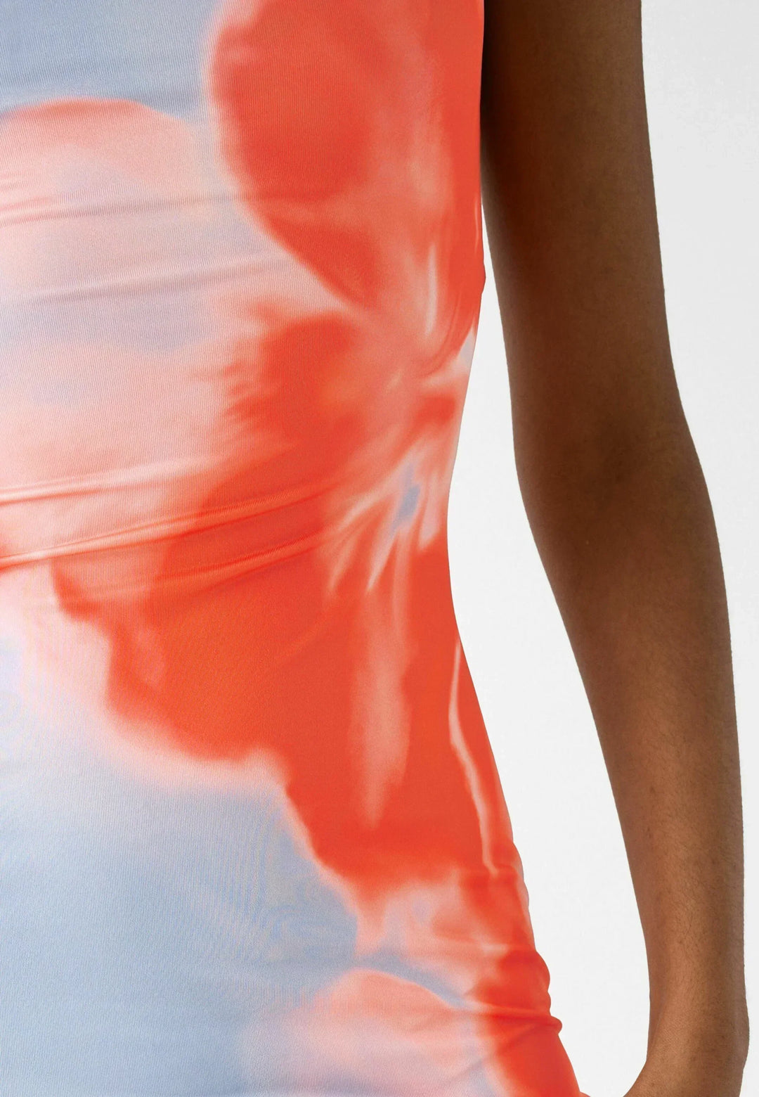 Close up view of the blue and red floral fabric pattern and side of the maxi dress