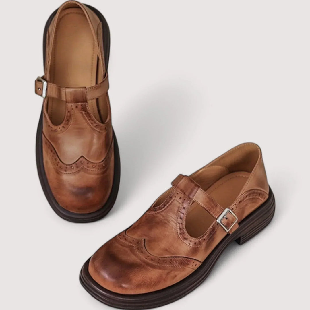 Two brown casual buckle Mary Jane shoes with T-strap and brogue detailing