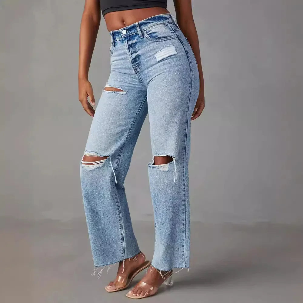 Women light blue ripped straight leg jeans showing high waist and knee rips, side view