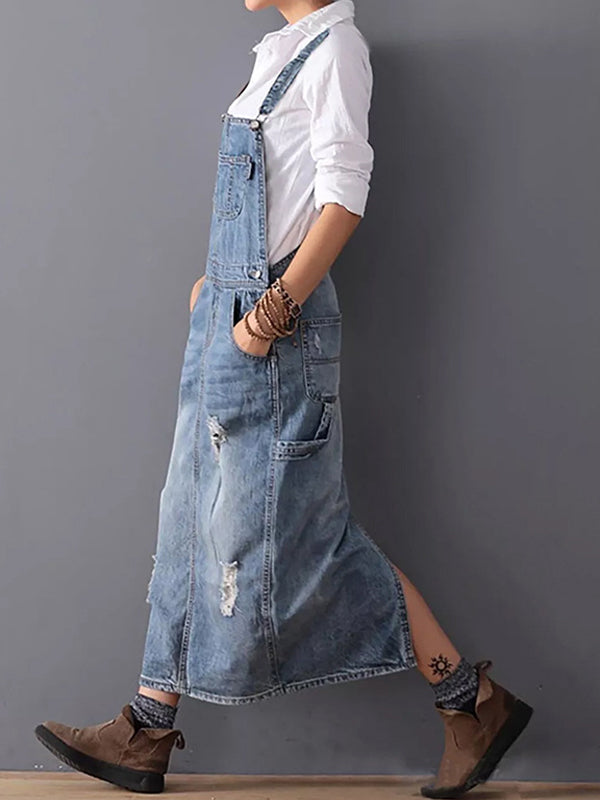 Women blue distressed denim pinafore midi dress, side view on model showing skirt split
