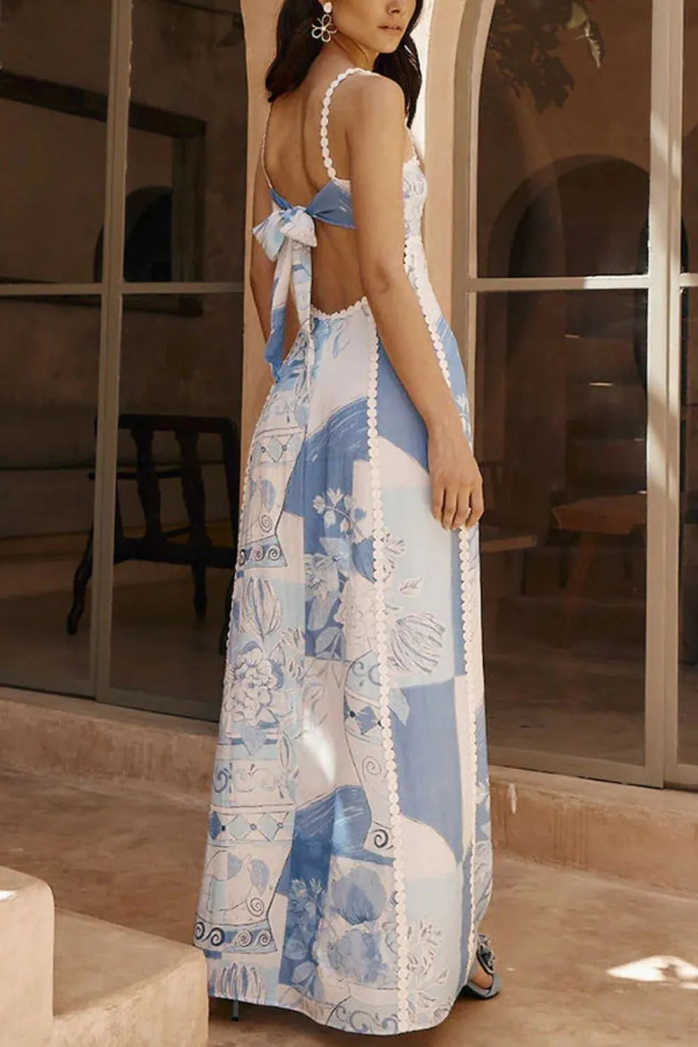 Women blue and white printed maxi dress with backless design and tie closure, back view.