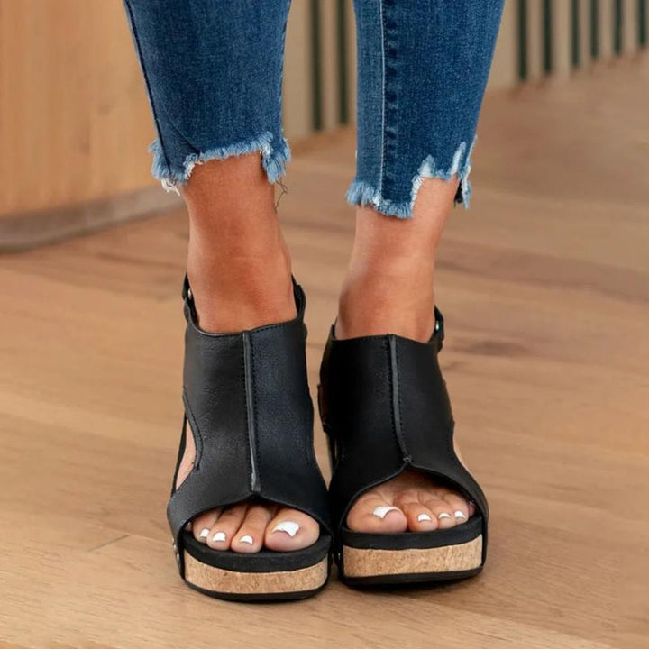Women's black open toe wedge sandals with cork sole and ankle strap closure, front view