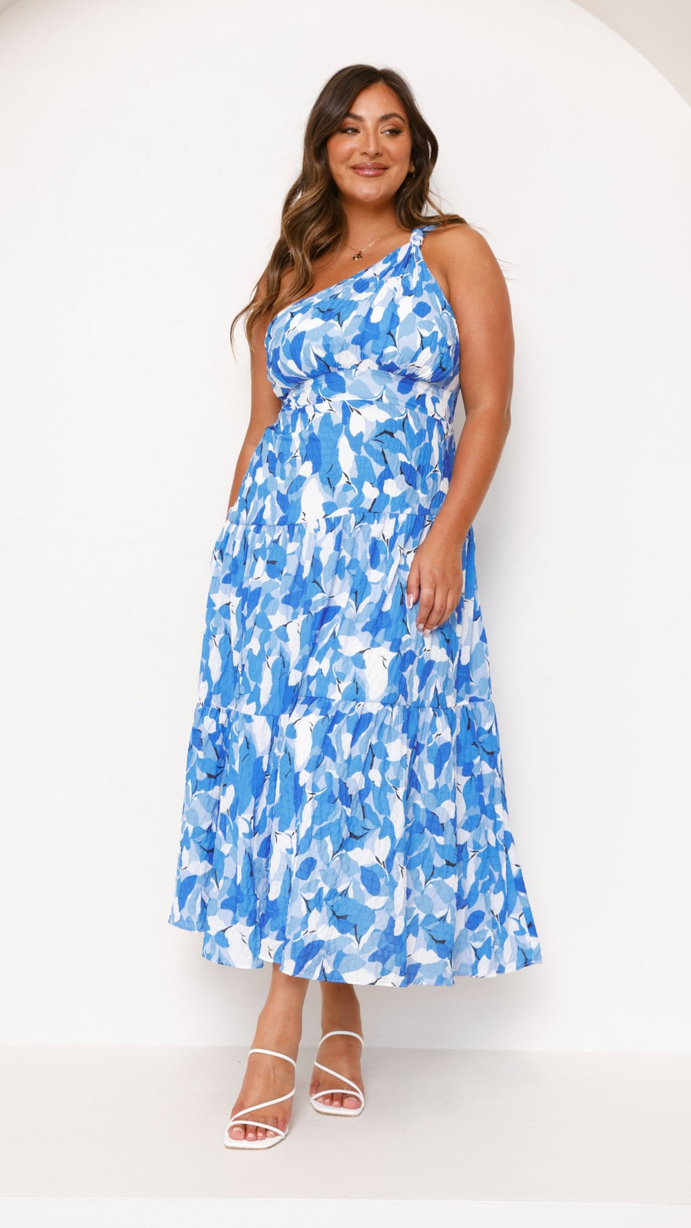 Women blue floral print midi dress, full length front view, one shoulder with tiered skirt