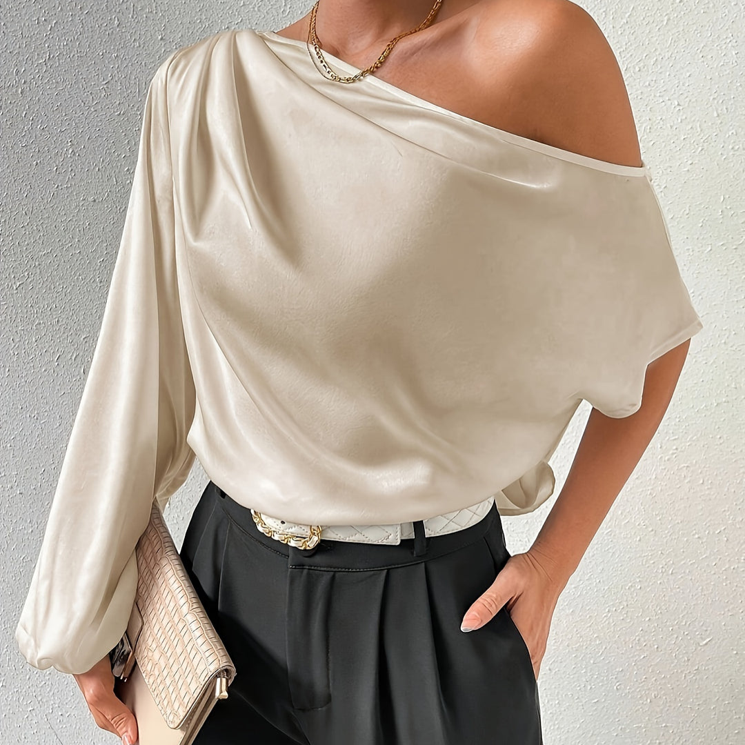 Women's ivory off-shoulder top with one long sleeve and one short sleeve, front view.