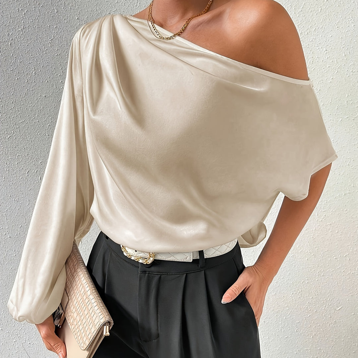 Women's ivory off-shoulder top with one long sleeve and one short sleeve, front view.