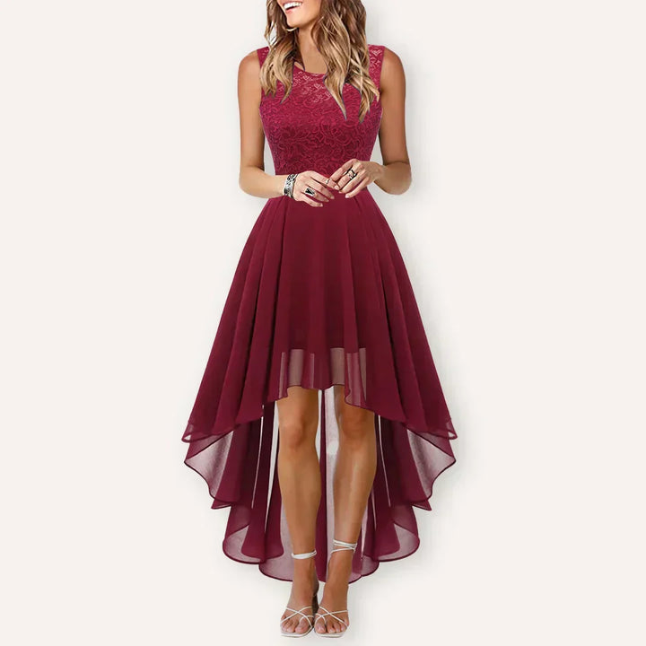 Women's sleeveless burgundy high low dress with detailed lace bodice, full body studio shot