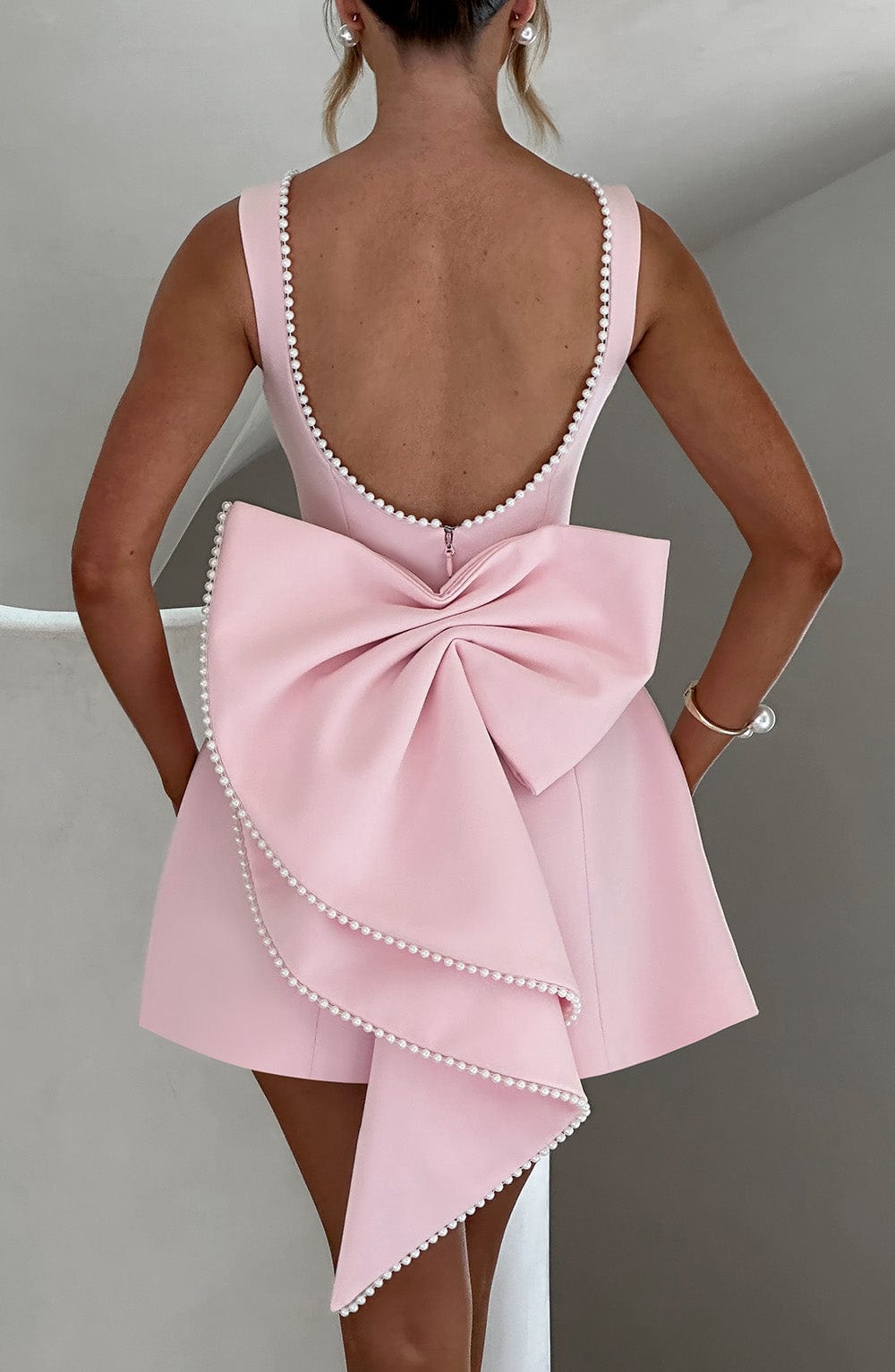 Women light pink mini dress with pearl-trimmed deep V-back and large bow
