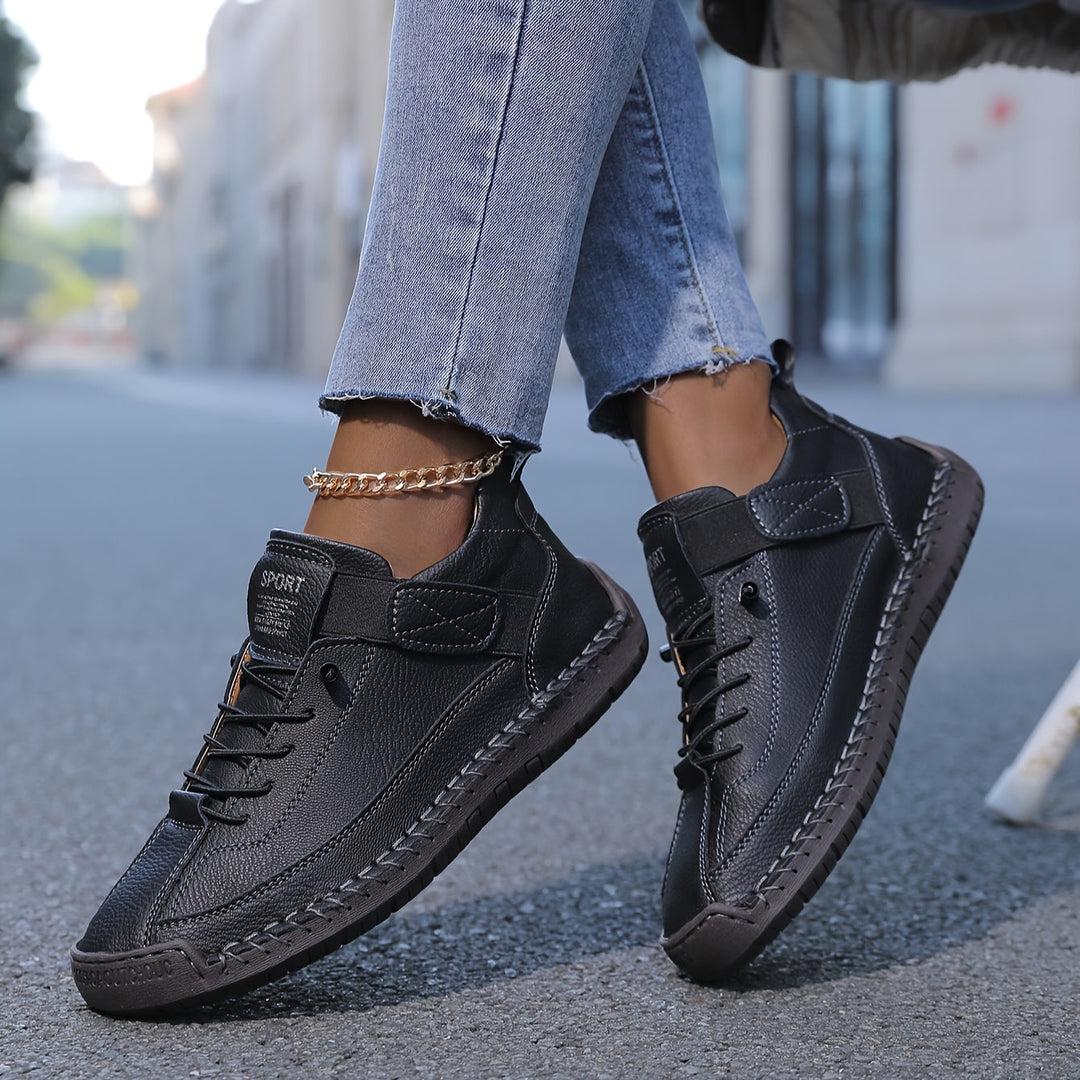 Women's black casual lace-up platform sneakers showing top view of laces, strap, and textured sole