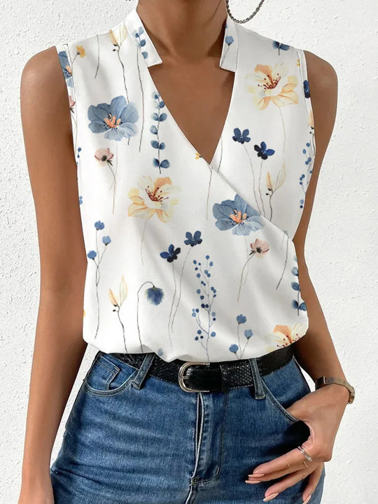 Women white floral V-neck sleeveless blouse with blue and orange flowers, angled front