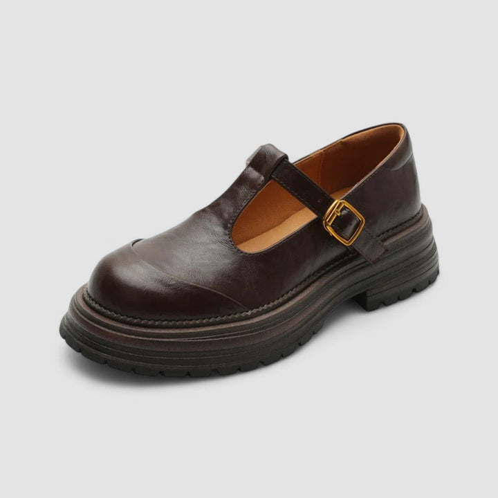 Single brown classic buckle mary jane platform shoe, angled view.
