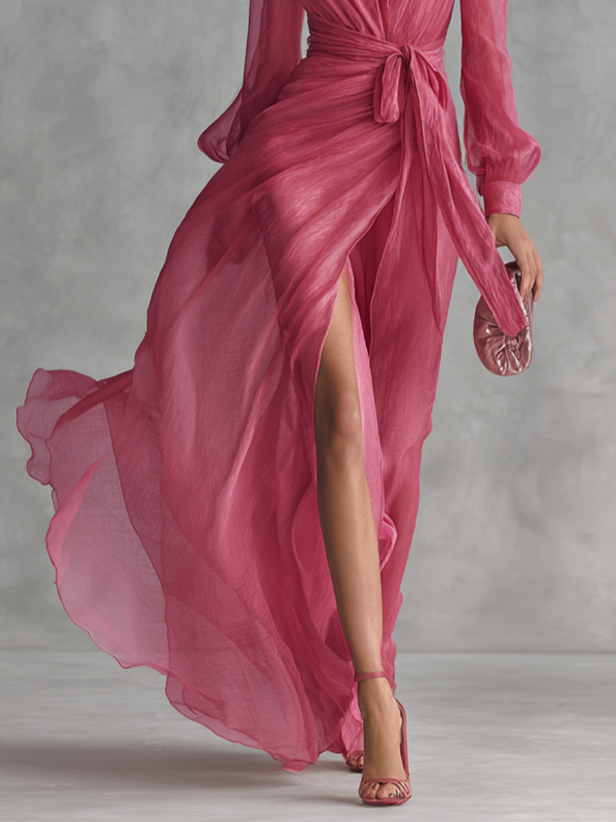 Lower section of pink maxi dress highlighting high side slit and flowing skirt detail.