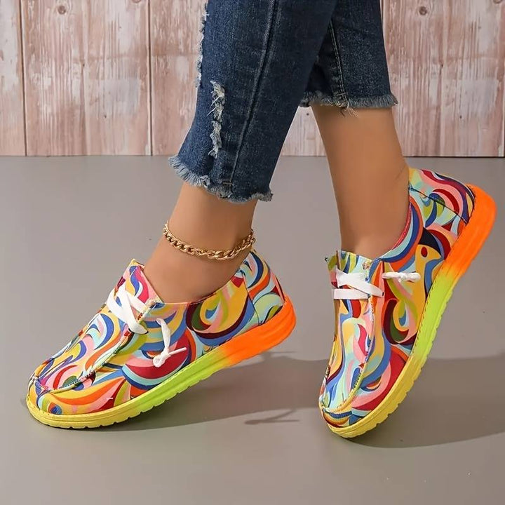 Women's brightly colored abstract printed sneakers with white laces and a multi-color sole.