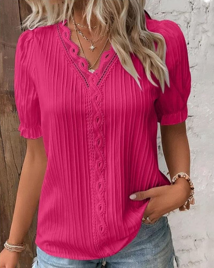 Women hot pink lace V neck puff sleeve blouse with textured fabric and ruffled cuffs.