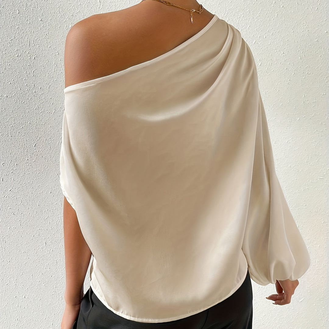Women's ivory draped off-shoulder top with one long sleeve, back view showing neckline.