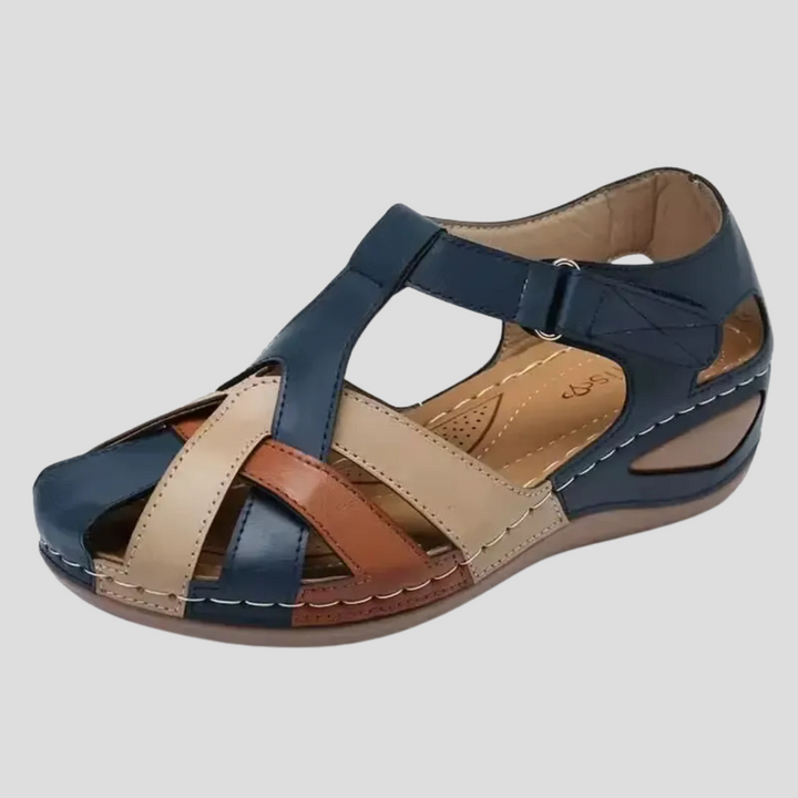 Women's navy blue multi-strap wedge sandals with beige and brown accents, detailed view