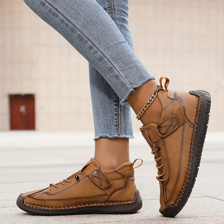 Women's brown lace-up platform sneakers from side profile, highlighting platform thickness and stitching