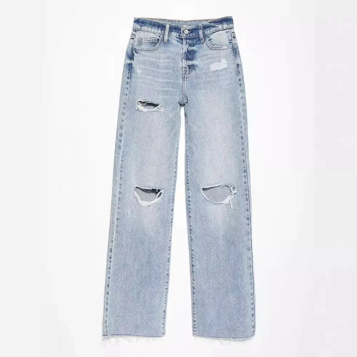 Light blue ripped straight leg jeans laid flat highlighting knee rips and frayed hem