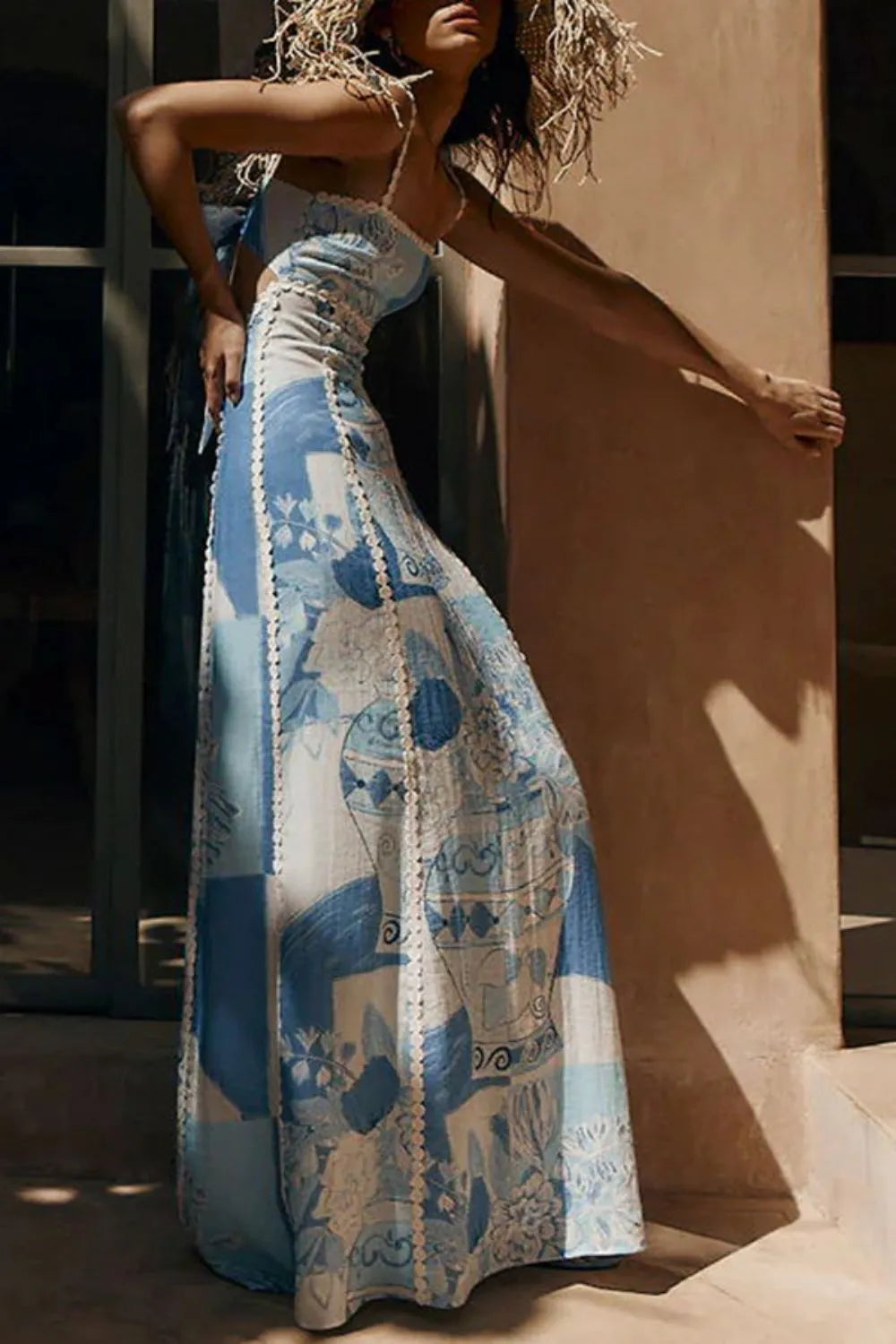 Women blue and white printed backless maxi dress with square neckline, side view.