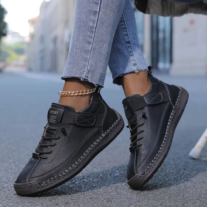 Women black lace-up low-profile walking sneakers with hook-and-loop strap and visible stitching