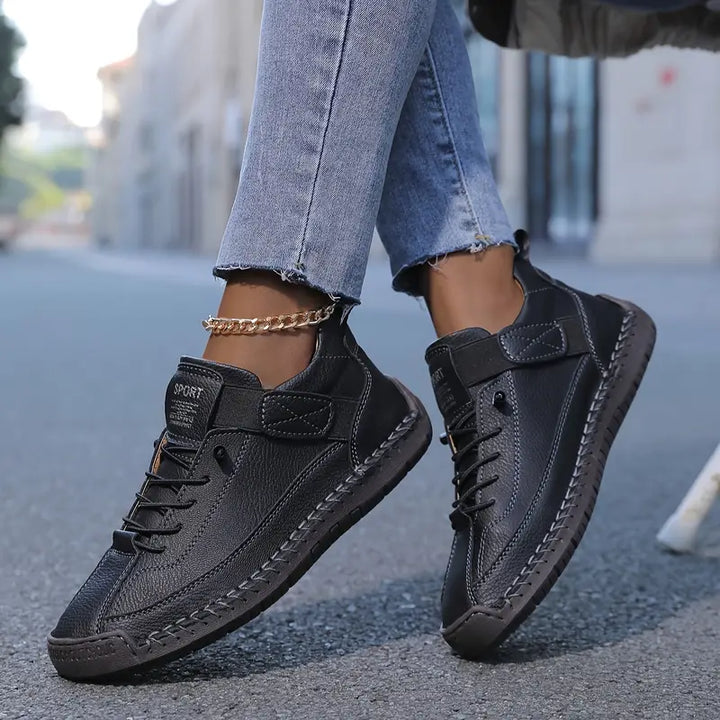 Women black lace-up low-profile walking sneakers with hook-and-loop strap and visible stitching