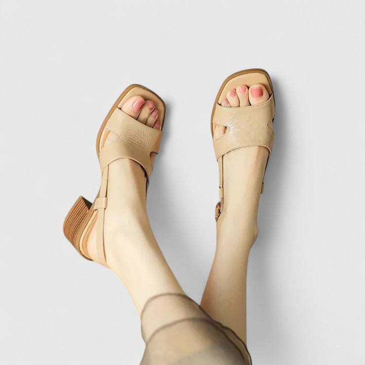 Women beige H-strap slingback sandals showing low block heel and square toe front