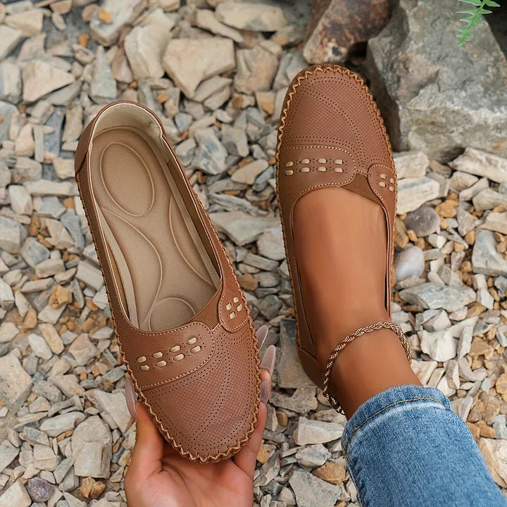 Women brown casual slip on shoes with perforated details, shown from an elevated perspective.