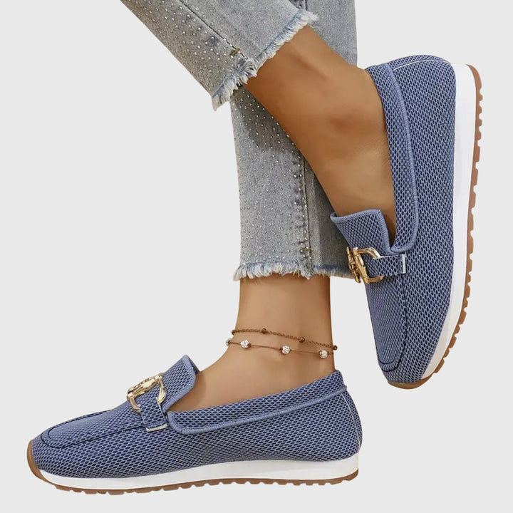 Women blue slip on buckle loafers with mesh upper, shown sideways on foot