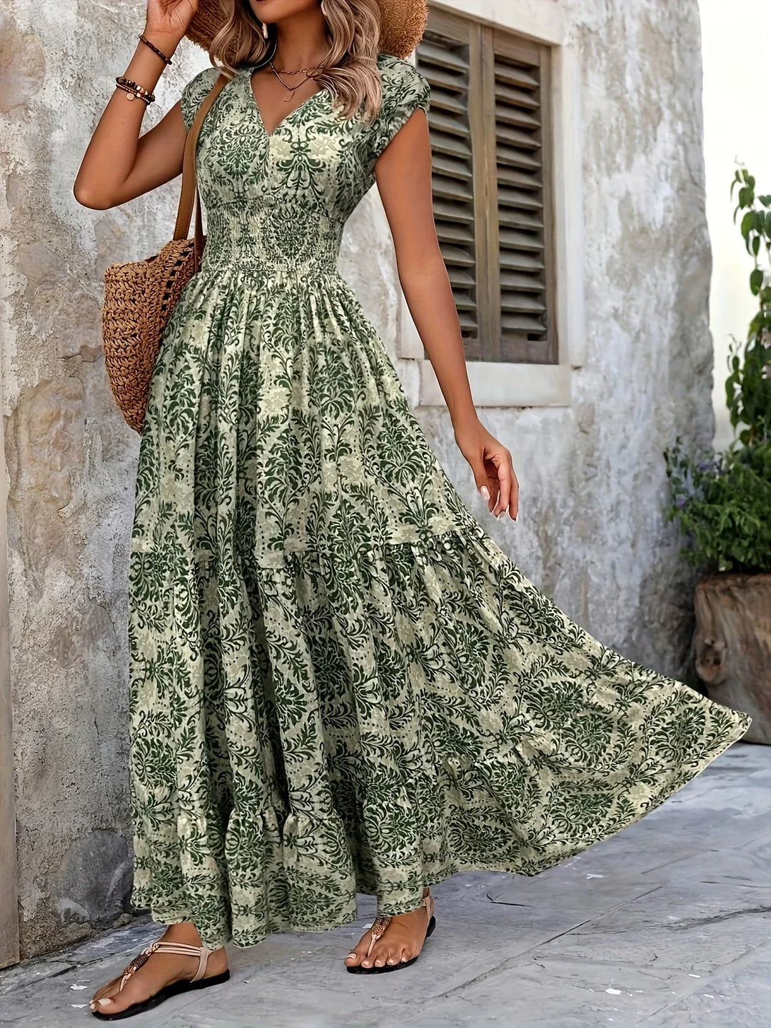 Women green paisley print maxi dress showing flowing tiered ruffle skirt in motion