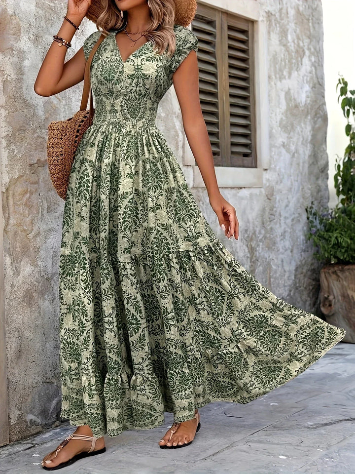 Women green paisley print maxi dress showing flowing tiered ruffle skirt in motion