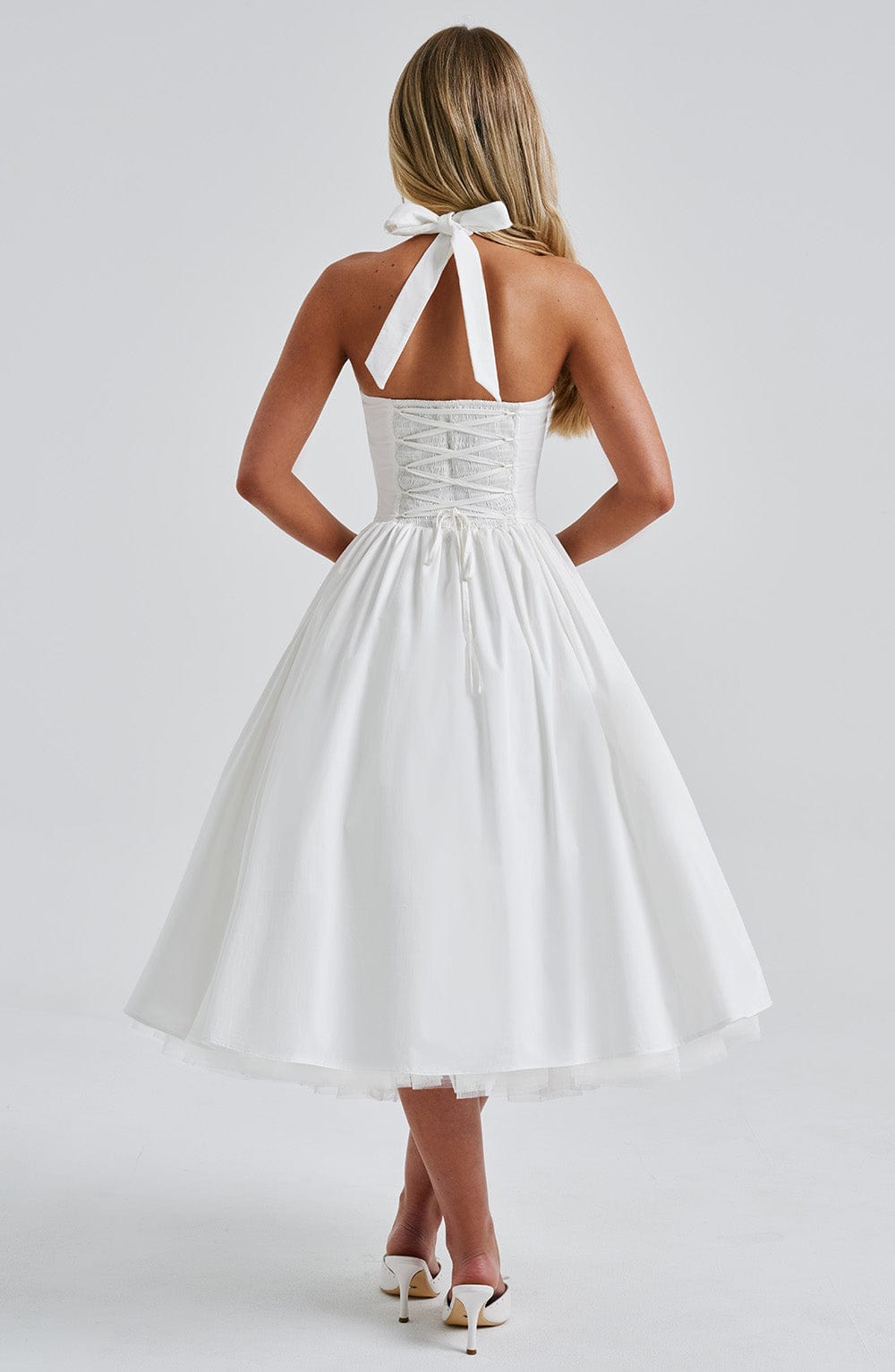 Women white halter neck midi dress with lace-up corset back and bow tie at neck, back view
