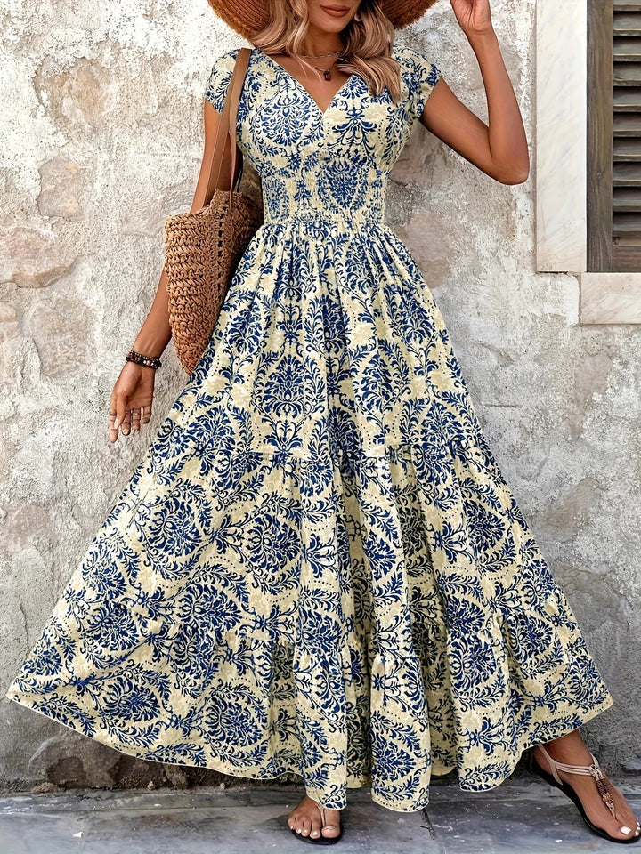 Women blue paisley print maxi dress with V-neck, short sleeves, shirred bodice, and ruffle hem