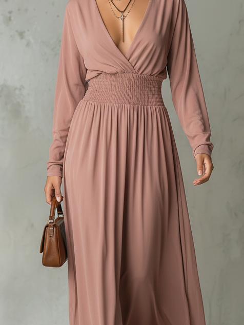 Close-up of smocked waist and V neckline on a rose pink maxi dress