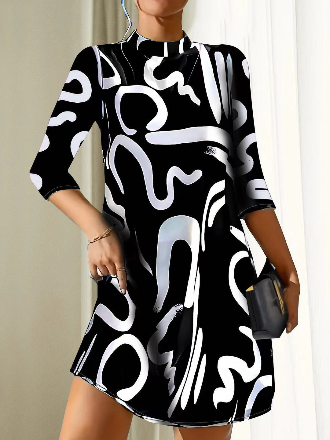 Women black and white printed mini dress with 3/4 sleeves, front view on model.