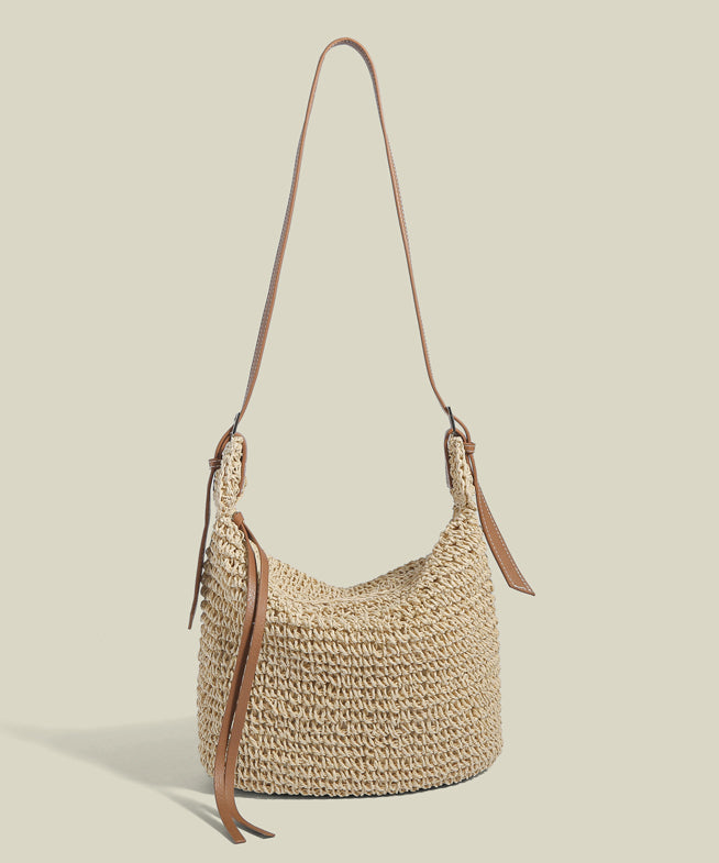 Women beige straw woven bucket bag with brown adjustable shoulder strap, front view