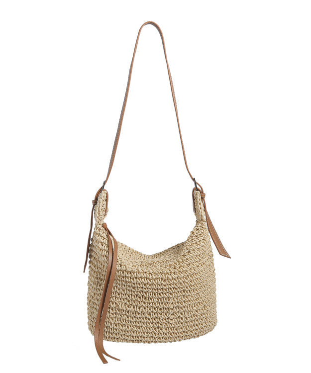 Women beige straw woven bucket bag with brown shoulder strap and loose ties, display view