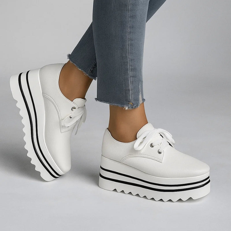 Women white platform wedge sneakers with black striped sole and sawtooth tread on light background