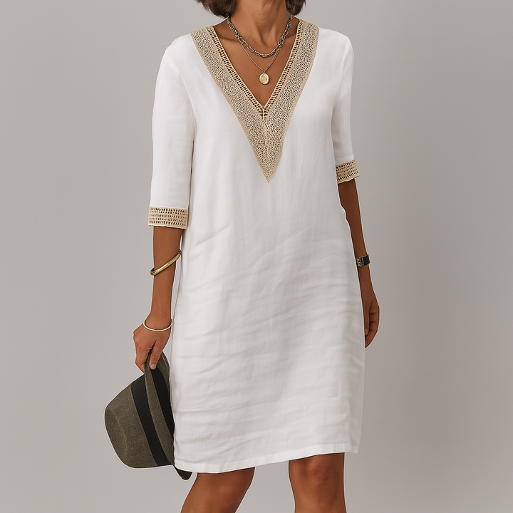 Women white V neck mini dress with crocheted trim and three-quarter sleeves, front view