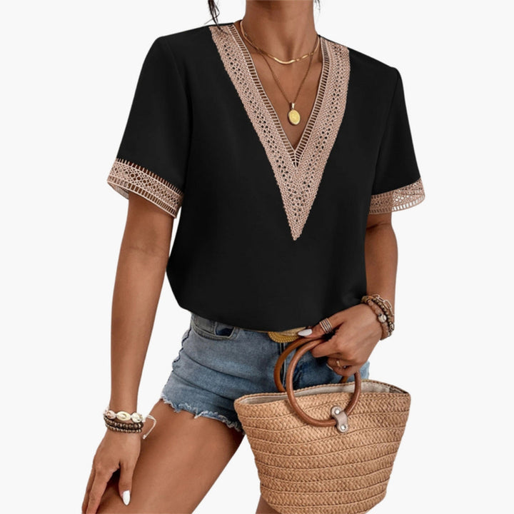 Women's black V-neck short sleeve blouse featuring lace trim accents on the V-neck and sleeve cuffs.